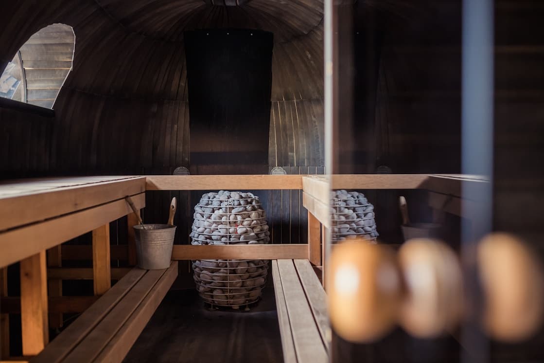 Interior of a wooden sauna with a stone stove